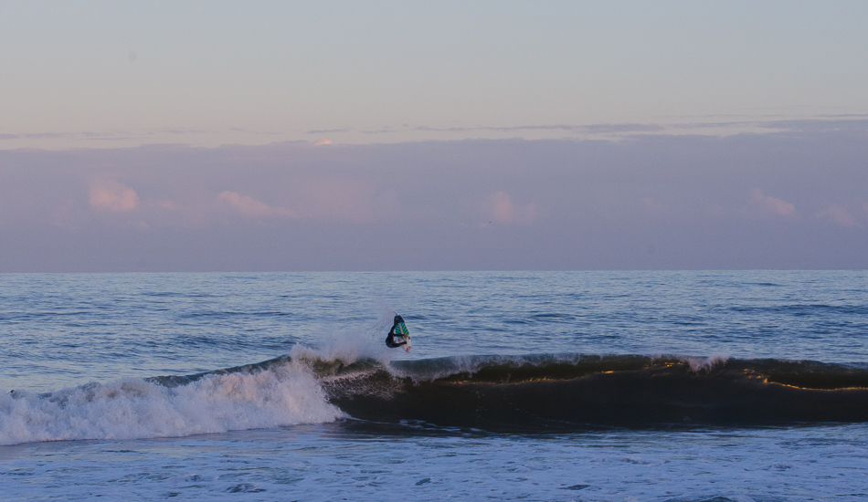 Dallas Tolson is the most stoked surfer on the Outer Banks and possibly on the planet. I shot this session for a couple of freezing hours after I surfing with Dallas as my primary target. Missed a shot here. Too much spray there. Thought it wasn\'t going to happen. Was taking lineup shots at dusk with my zoom pulled back and out of the corner of my eye I catch Dallas boosting this air. Zoomed out with the purple of dusk, makes this one of my favorite shots.